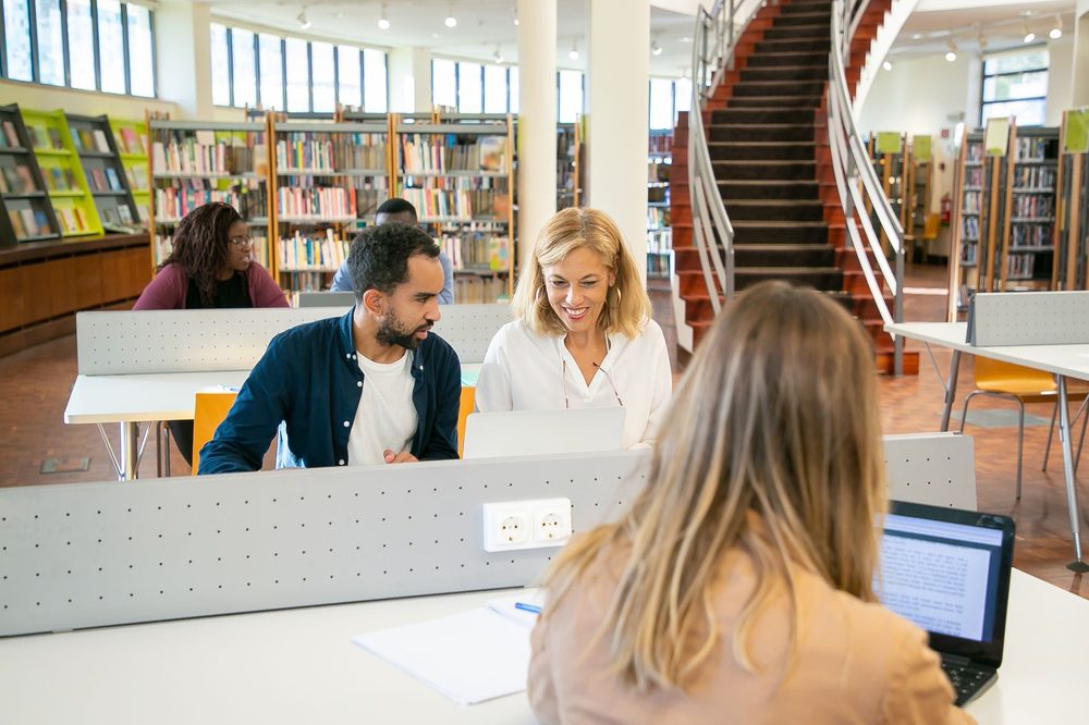 Students at laptops in a university library